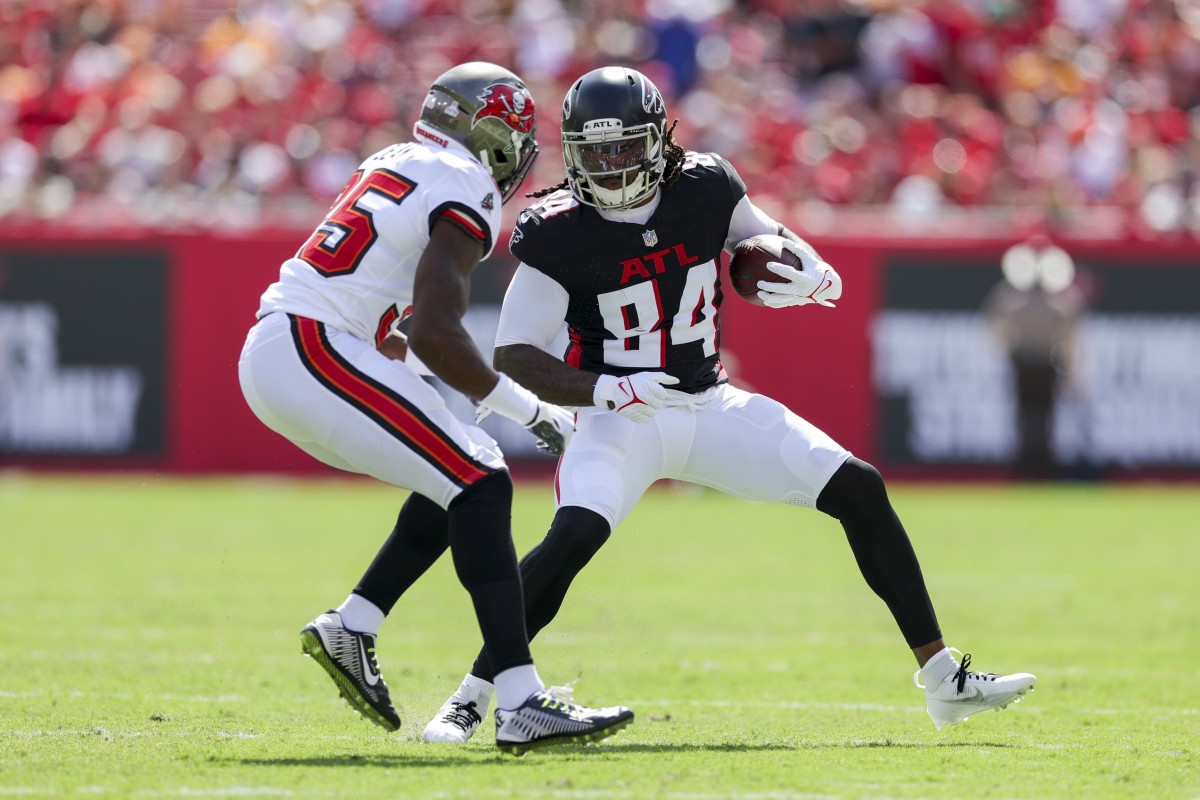 Oct 22, 2023; Tampa, Florida, USA; Atlanta Falcons running back Cordarrelle Patterson (84) runs with the ball defended by Tampa Bay Buccaneers cornerback Jamel Dean (35) in the first quarter at Raymond James Stadium. Mandatory Credit: Nathan Ray Seebeck-USA TODAY Sports  